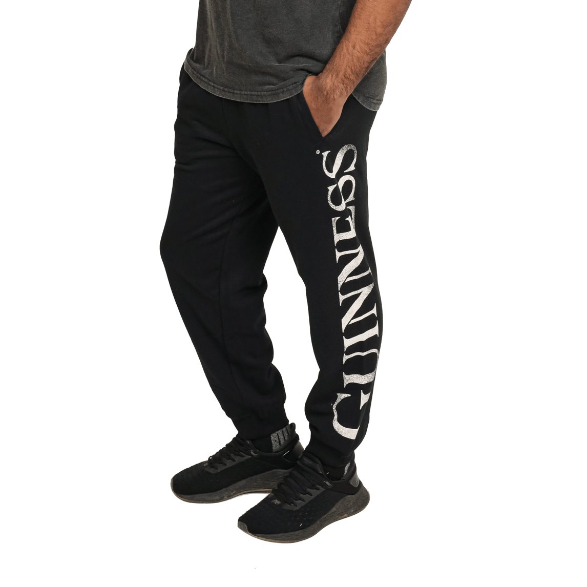 A man wearing comfortable Guinness joggers made of organic cotton.