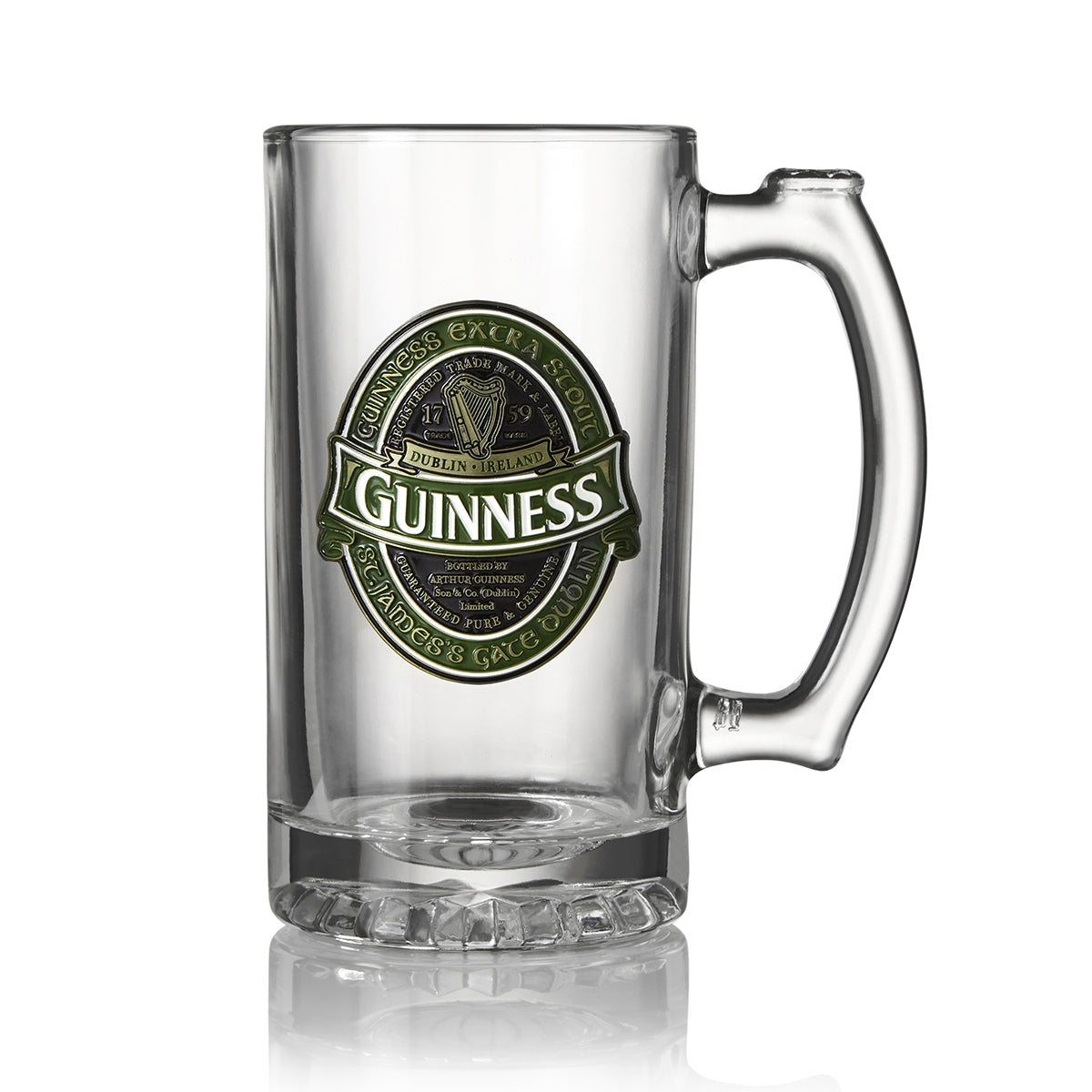 A clear glass beer mug with a handle, featuring the iconic Guinness label on the front detailing its origin from Dublin, Ireland.