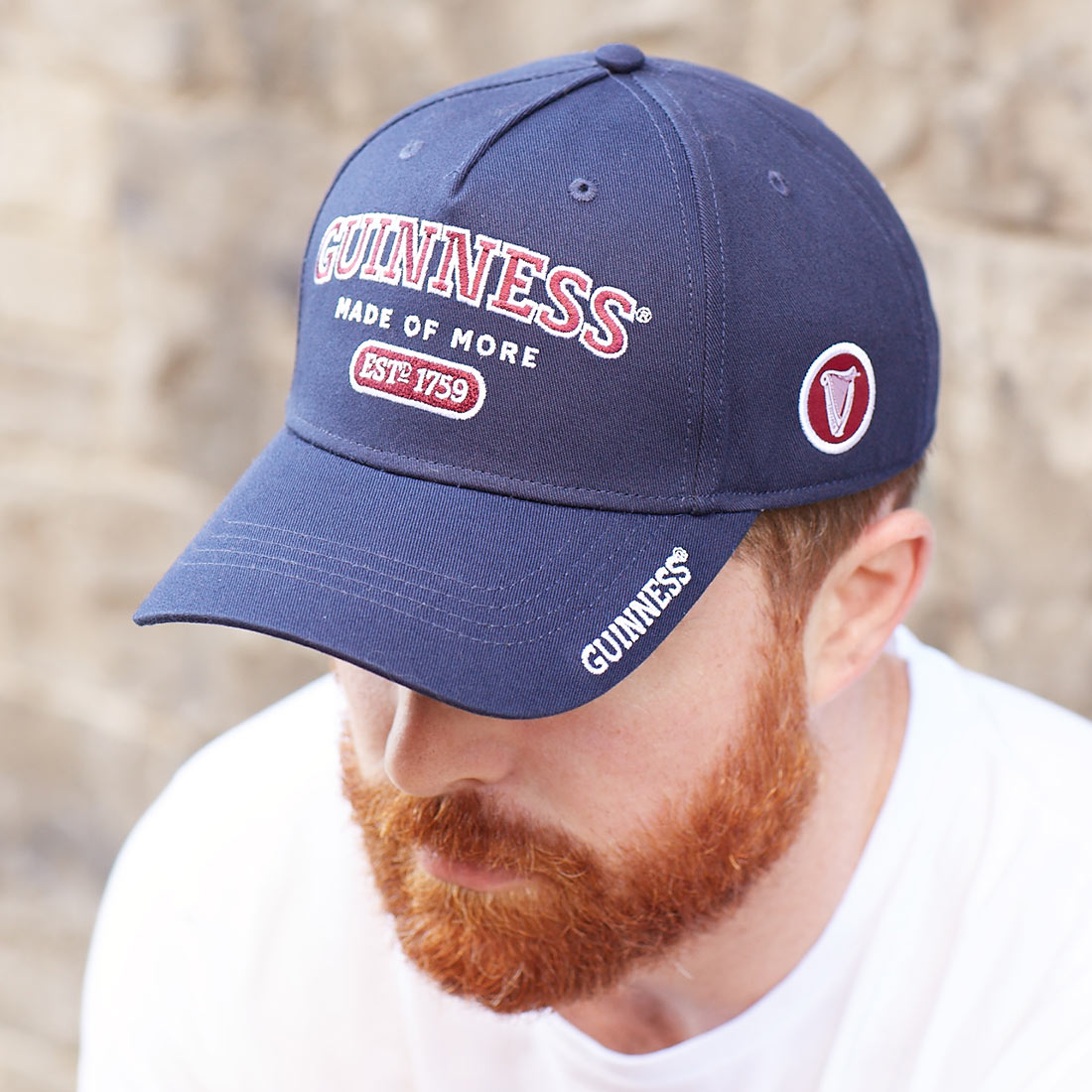 A man sporting an adjustable Guinness Signature Blue Baseball Cap in style.