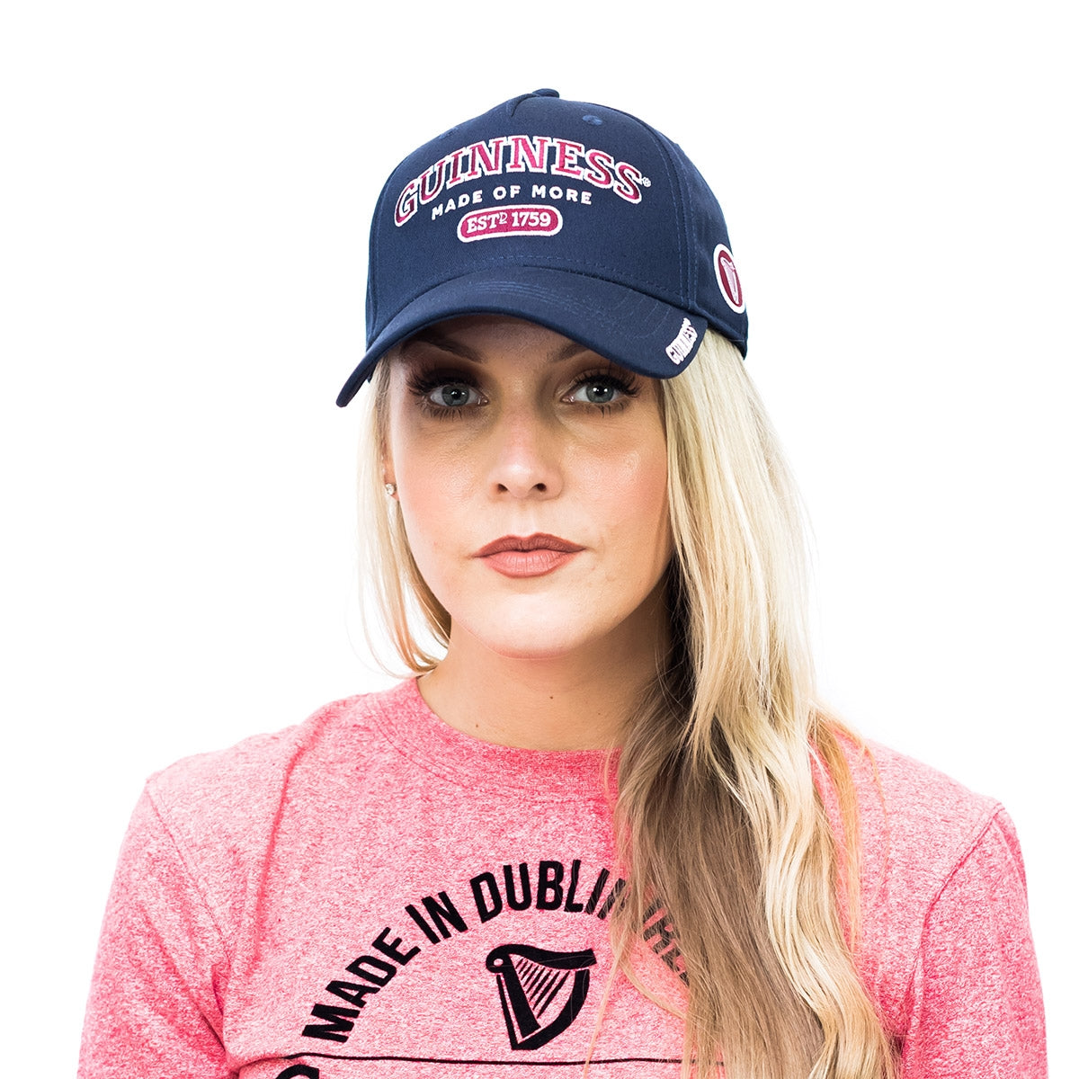 A blonde woman wearing an adjustable Guinness Signature Blue Baseball Cap Adjustable.