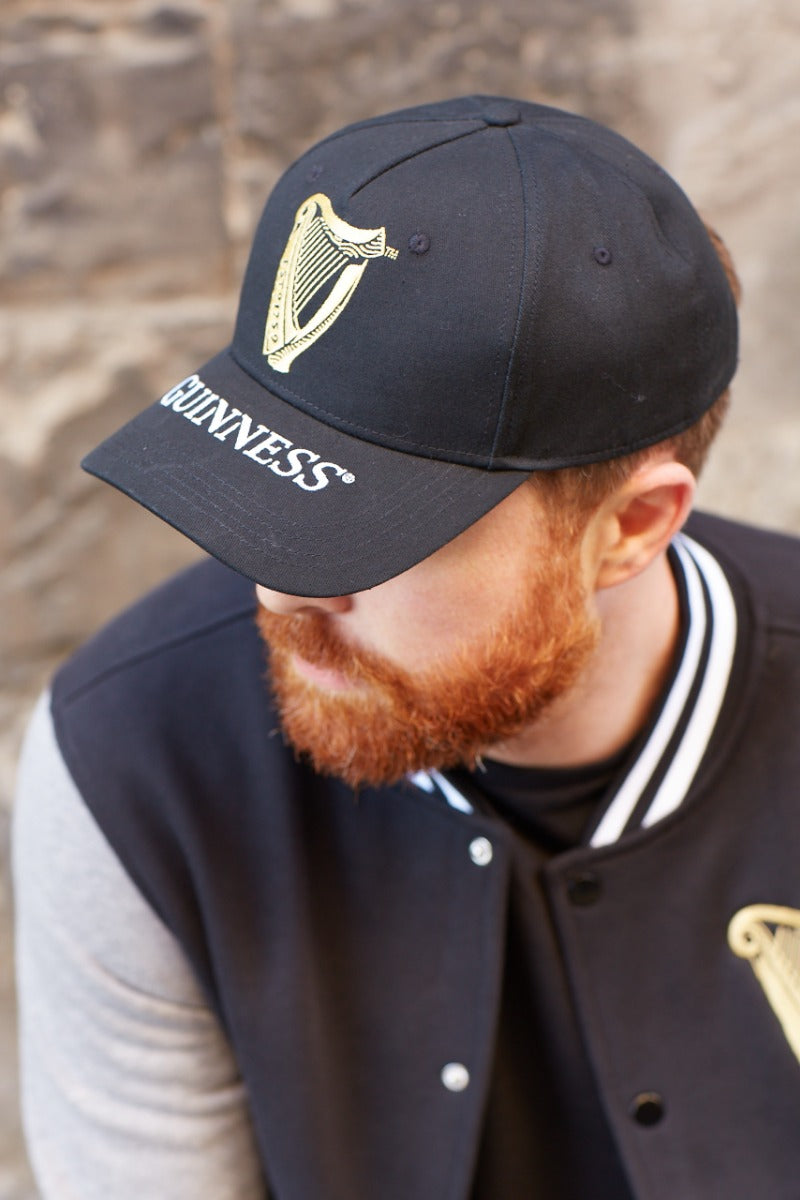 A man with a beard wearing a Guinness Harp Baseball Cap.