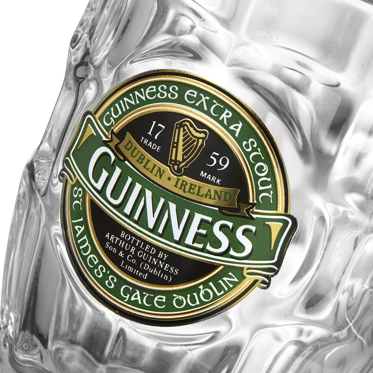 Close-up of a Guinness beer bottle label, showing the text "Guinness Extra Stout," "St. James's Gate Dublin," and "Bottled by Arthur Guinness Son & Co." with a harp logo and "Dublin, Ireland" markings—perfectly complemented by a high-quality glass Guinness Ireland Dimpled Tankard from Guinness.