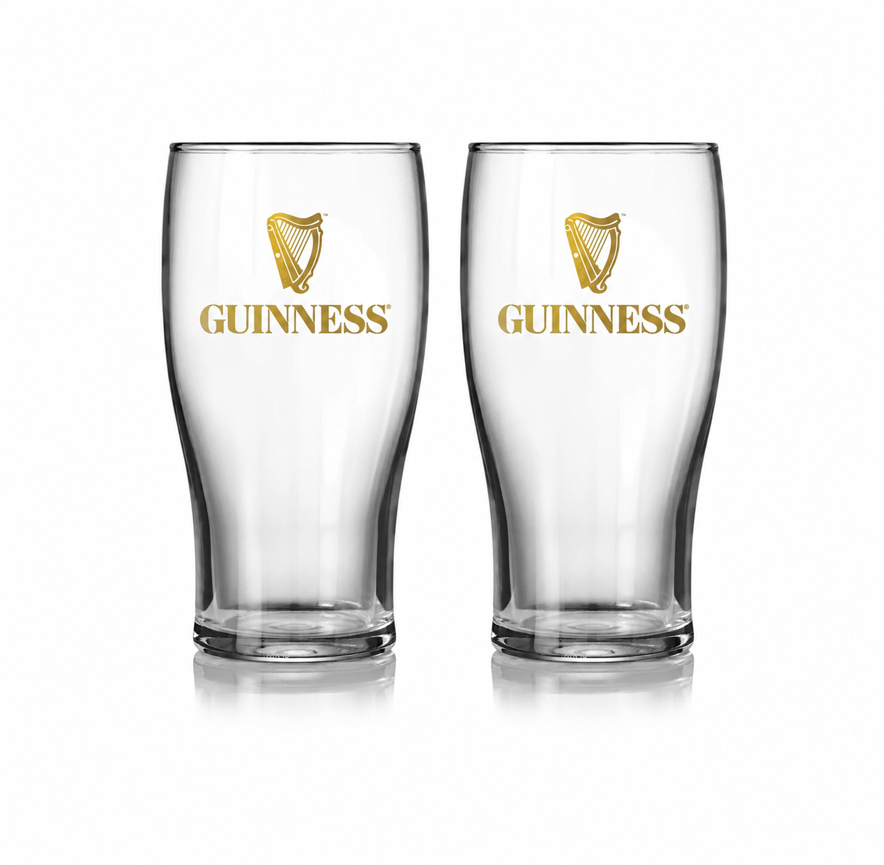 Two clear Guinness pint glasses with gold harp logos and the brand name printed on the front, shown side by side on a white background.