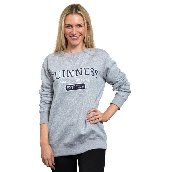 A woman wearing a Guinness Grey Crew Neck Sweatshirt.